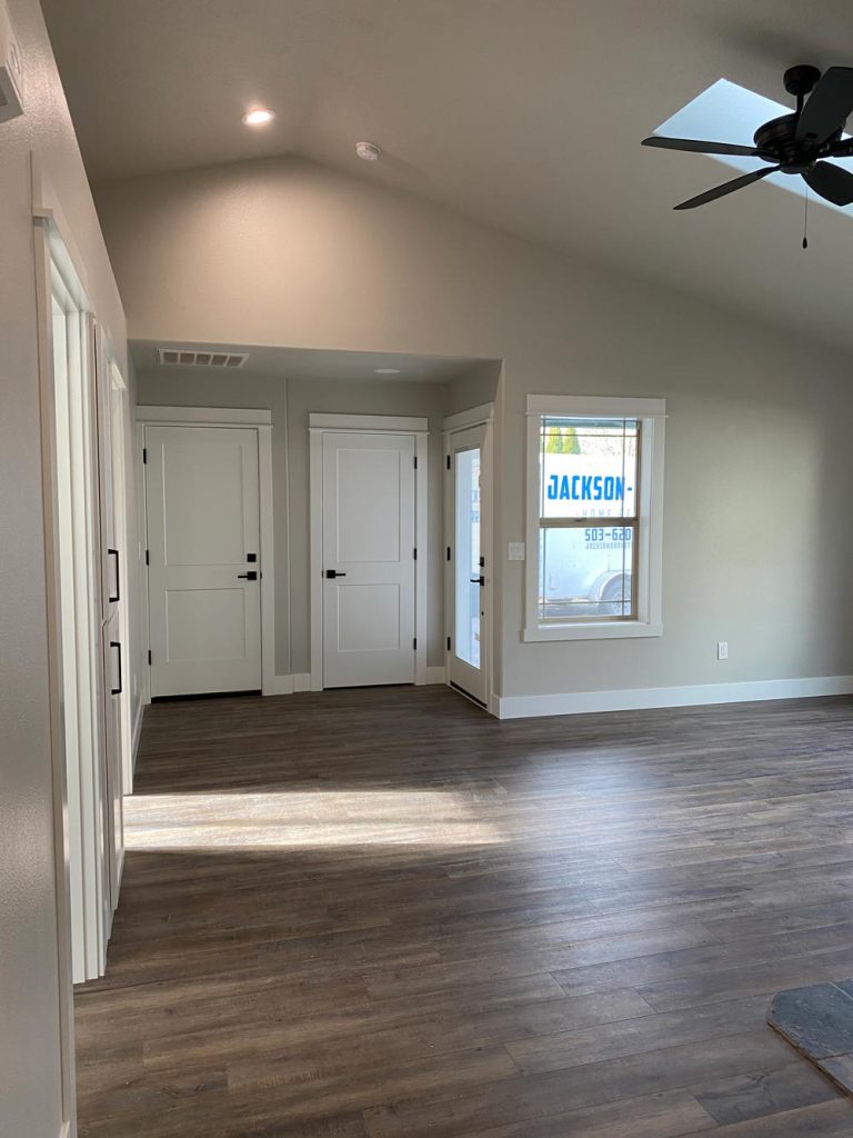 Room after window and door replacement, new flooring and finishes