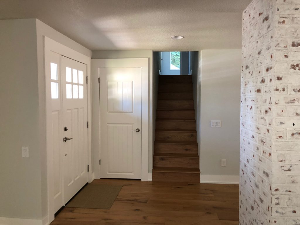 Remodeled stairway and entry with new door and finishes